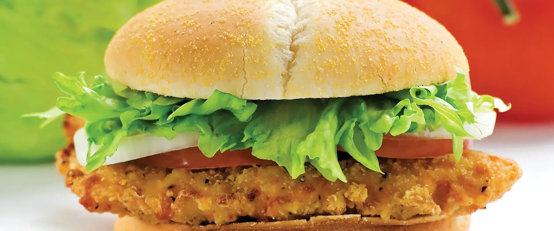 Sandwich with breaded chicken patty and fresh lettuce, tomato and onion.