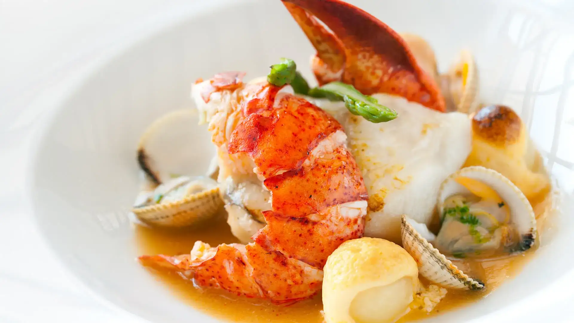 Seafood in a bowl with sauce.