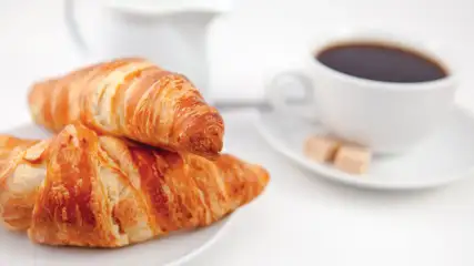 Fresh croissants with a cup of coffee.