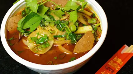 Bowl of pho and chopsticks.