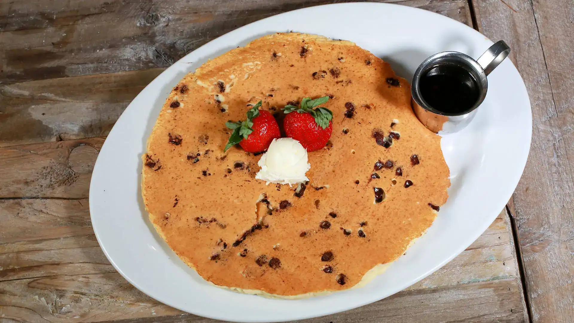 Hash House a Go Go Flapjack with strawberries, butter and syrup