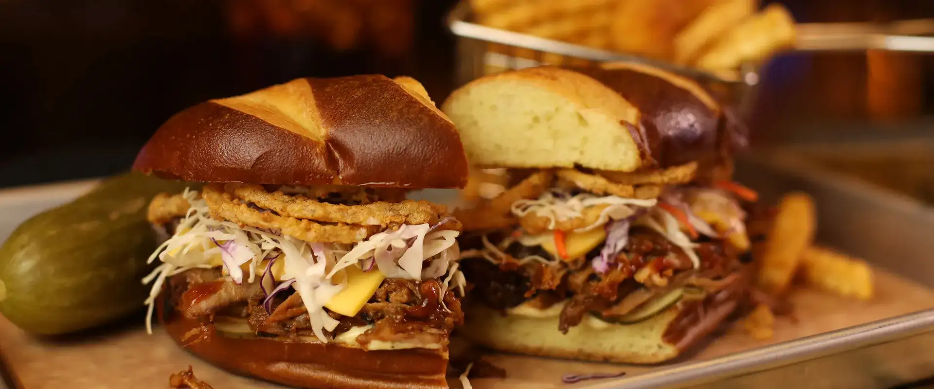 Motley Que pulled pork sandwich with fries and pickle on the side.