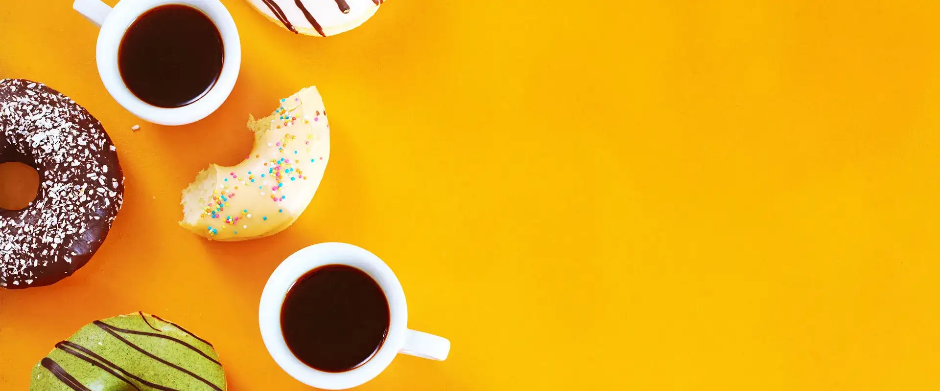 Donuts and coffee on a yellow background
