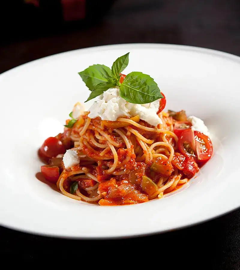 Spaghetti with tomato sauce, mozzarella, and basil.