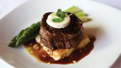 Steak and Asparagus on white plate at The Steakhouse at Caesars New Orleans