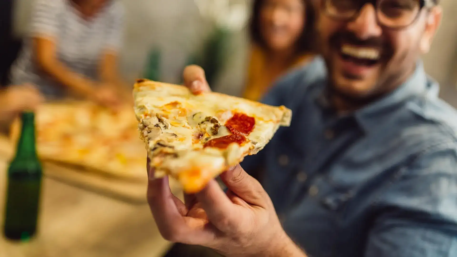 Man holding a pizza slice