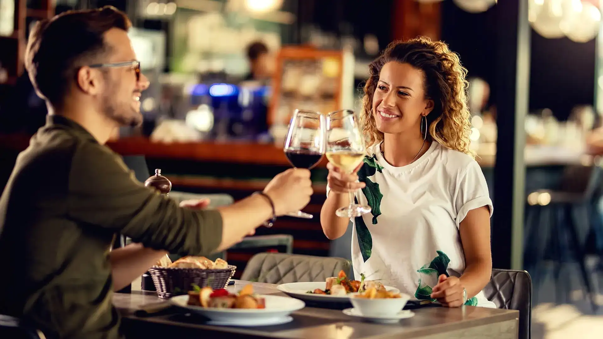 Couple toasting at the dinner table.