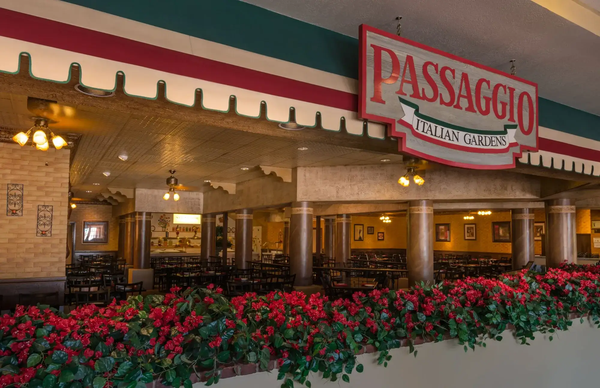 Exterior view of Passaggio showing signage and flowers