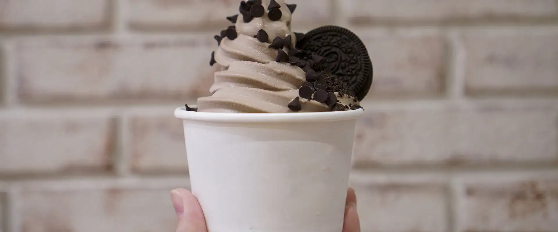 Frozen Yogurt with oreo cookie on top.
