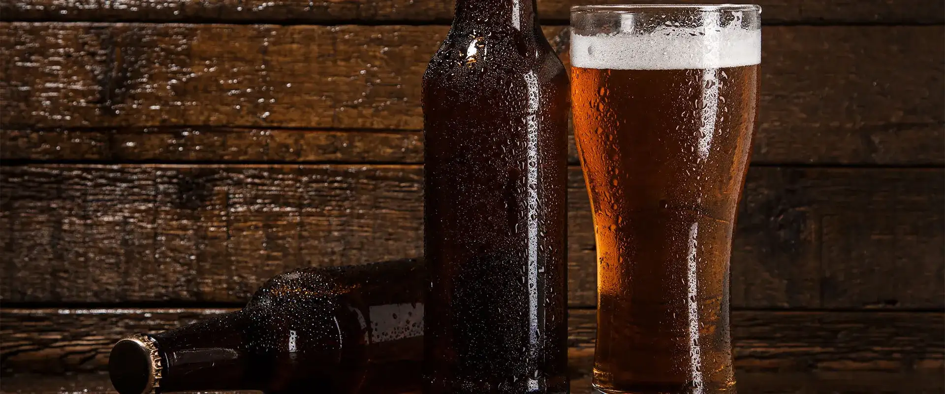 Beer bottles and glass of beer.