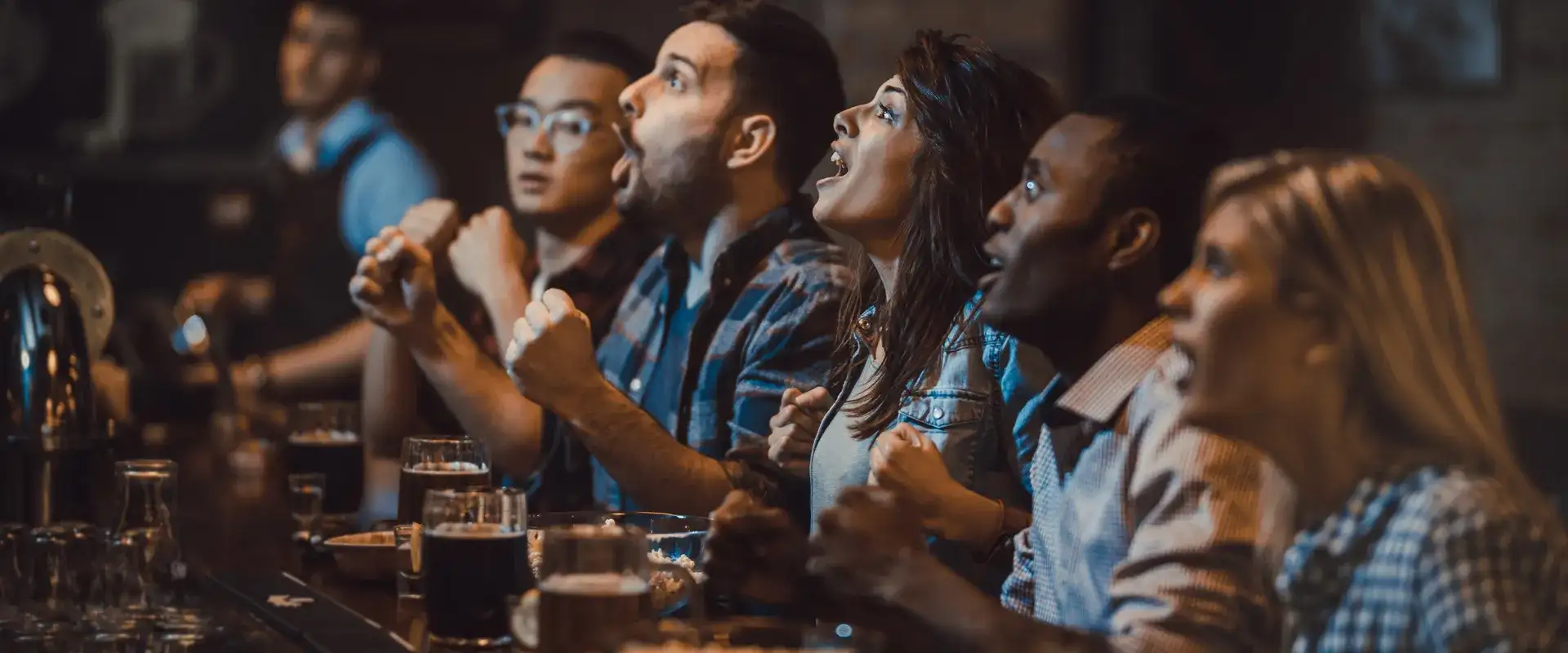 People sitting at the bar cheering.