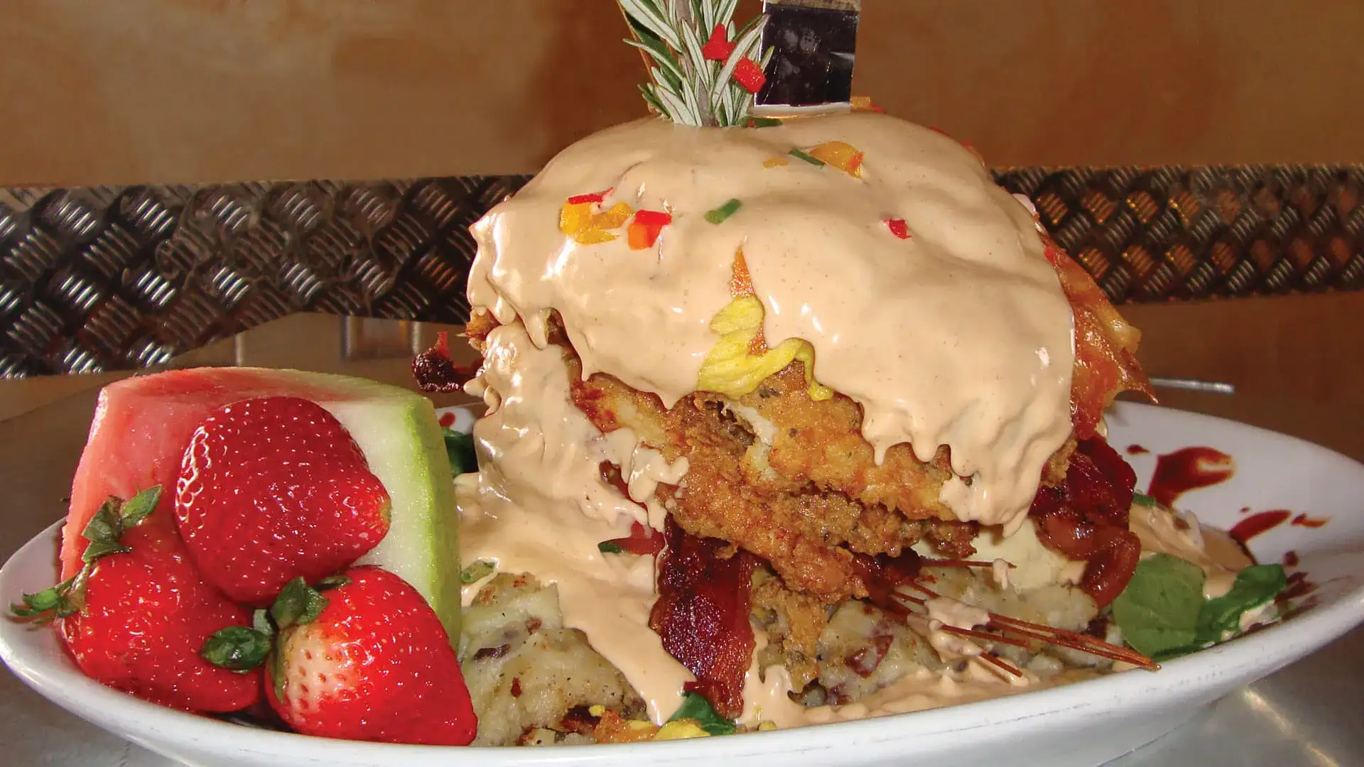 Hash House a Go Go Chicken Benedict with strawberries and watermelon